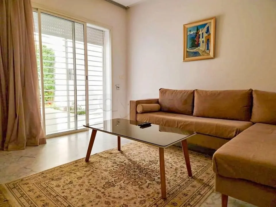 A louer un appartement S2 meuble au rez-de-chaussee avec jardin situe a ENNASR 2